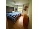 Bedroom with wood floors, ceiling fan, and window with natural light at 945 College Hill Dr, Clearwater, FL 33765