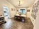 Dining room with hardwood floors, modern lighting, and natural light filtering through the window at 945 College Hill Dr, Clearwater, FL 33765