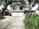 Well-maintained two-story home with a two-car garage and a beautifully landscaped front yard at 945 College Hill Dr, Clearwater, FL 33765