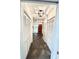 Hallway featuring decorative doors, dark tiles, and modern lighting fixtures at 945 College Hill Dr, Clearwater, FL 33765