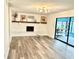 Bright room featuring a decorative fireplace, hanging chair, and a sliding glass door at 945 College Hill Dr, Clearwater, FL 33765
