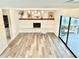 Bright room featuring a decorative fireplace, hanging chair, and a sliding glass door at 945 College Hill Dr, Clearwater, FL 33765