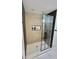 Modern shower featuring geometric tile, white floors, a shower niche, and black framed glass door at 945 College Hill Dr, Clearwater, FL 33765
