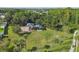 This aerial view showcases a playground surrounded by a forest of mature trees with walking path at 1032 Jacob Way, Odessa, FL 33556