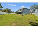 Expansive backyard with lush green grass, white fence, basketball hoop and a covered patio, perfect for outdoor activities at 1032 Jacob Way, Odessa, FL 33556