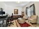Inviting home office with comfortable seating, modern desk, and natural light for productivity at 1032 Jacob Way, Odessa, FL 33556