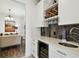 Kitchen beverage center with wine rack, glass storage and mini fridge, perfect for entertaining at 1032 Jacob Way, Odessa, FL 33556