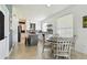 Bright eat-in kitchen with white cabinetry, stone countertops, and an island with seating at 1032 Jacob Way, Odessa, FL 33556