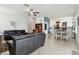 Open concept living room with tile floors, comfortable seating, and seamless flow to kitchen at 1032 Jacob Way, Odessa, FL 33556