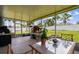 Enclosed patio overlooking lush backyard with mature trees at 1032 Jacob Way, Odessa, FL 33556