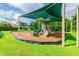 This shaded playground has a playset with slides and covered roofs on a wood chip surface at 1032 Jacob Way, Odessa, FL 33556