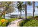 Lush waterfront property with a wooden dock for boat access at 11055 7Th E St, Treasure Island, FL 33706