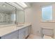 Bright bathroom featuring gray vanity, quartz countertop, tile backsplash, and accessible shower at 11055 7Th E St, Treasure Island, FL 33706