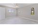 Neutral bedroom featuring light tile floors, clean trim, and multiple windows for great natural light at 11055 7Th E St, Treasure Island, FL 33706