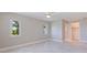 This bedroom features neutral walls, tile floors, two windows, and an ensuite bathroom at 11055 7Th E St, Treasure Island, FL 33706