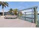 Dock with a boat lift overlooking the serene waterway with waterfront homes in the background at 11055 7Th E St, Treasure Island, FL 33706