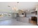 Open kitchen and living room layout with sleek bar, stainless appliances, and island at 11055 7Th E St, Treasure Island, FL 33706