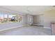 Bright living room features large windows, tiled floors, and neutral tones at 11055 7Th E St, Treasure Island, FL 33706