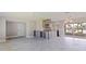 Large living area with tiled floor, custom bar, chandelier and access to screened-in patio at 11055 7Th E St, Treasure Island, FL 33706