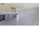 Open-concept living area with gray tile flooring, custom cabinets, and modern lighting at 11055 7Th E St, Treasure Island, FL 33706