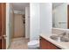 Modern bathroom with glass shower and light brown tiled walls, sink and mirror at 111 N 12Th St # 1707, Tampa, FL 33602