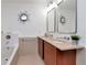 Bathroom with double vanity, sunburst mirror and soaking tub with ceramic tile at 111 N 12Th St # 1707, Tampa, FL 33602