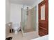 Modern bathroom with glass shower and light brown tiled walls and floor at 111 N 12Th St # 1707, Tampa, FL 33602