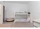 Bunk bedroom with white bunkbeds, an ottoman and gray area rug at 111 N 12Th St # 1707, Tampa, FL 33602