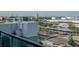 A downtown view from a condo balcony overlooking the street, parking lot and Tampa Bay harbor at 111 N 12Th St # 1707, Tampa, FL 33602