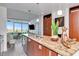 Kitchen with stainless steel appliances, stone counters, and an open layout to the light-filled living area with water views at 111 N 12Th St # 1707, Tampa, FL 33602