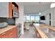 Modern kitchen with stainless steel appliances and stone counters looking into a bright living space with a view at 111 N 12Th St # 1707, Tampa, FL 33602