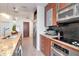 Contemporary kitchen features stainless appliances, stone counters, bar seating, and access to other rooms at 111 N 12Th St # 1707, Tampa, FL 33602