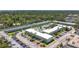 Aerial view of a multi-unit condo complex with a swimming pool, and ample parking at 1433 S Belcher Rd # B11, Clearwater, FL 33764