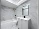 Updated bathroom with gray marble tile, white fixtures, and modern black accents at 1433 S Belcher Rd # B11, Clearwater, FL 33764