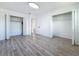 Spacious bedroom featuring wood-look flooring, neutral walls, and ample closet space at 1433 S Belcher Rd # B11, Clearwater, FL 33764