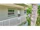 Second story walkway and front door of a condo unit with lush landscaping at 1433 S Belcher Rd # B11, Clearwater, FL 33764