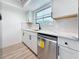 Bright kitchen with updated cabinets, stainless steel dishwasher, modern faucet, and stylish countertops at 1433 S Belcher Rd # B11, Clearwater, FL 33764