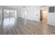 Open-concept living area with modern flooring and updated finishes, connecting seamlessly to the kitchen at 1433 S Belcher Rd # B11, Clearwater, FL 33764