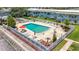 Beautiful community pool with ample seating surrounded by lush landscaping and well-maintained building at 1433 S Belcher Rd # B11, Clearwater, FL 33764