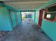 Carport with painted walls and storage room at 1504 Stevensons Dr, Clearwater, FL 33755