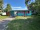 A colorful one-story home with a covered carport and small front yard at 1504 Stevensons Dr, Clearwater, FL 33755