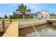 A lush backyard features a dock and a scenic canal view, perfect for relaxing and enjoying waterfront living at 15525 Old Dixie Hwy, Hudson, FL 34667