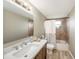 Well-lit bathroom with a tub and shower combination, stylish vanity, and wood-look tile floors at 15525 Old Dixie Hwy, Hudson, FL 34667