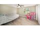Bedroom featuring wood-look tile flooring, a ceiling fan, and a sunny window view at 15525 Old Dixie Hwy, Hudson, FL 34667