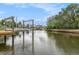 A scenic view of the canal showcasing the tranquil waterfront living experience with docks and boat lifts at 15525 Old Dixie Hwy, Hudson, FL 34667