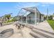 Exterior view of the screened lanai, backyard, and dock, providing a seamless blend of indoor and outdoor living at 15525 Old Dixie Hwy, Hudson, FL 34667