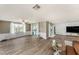 Open living room features tile floors, accent molding, and sliding glass doors to the outdoor pool and patio at 15525 Old Dixie Hwy, Hudson, FL 34667