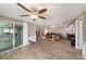 Expansive living room featuring an open floor plan and sliding glass doors to pool area at 15525 Old Dixie Hwy, Hudson, FL 34667