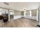 Bright and airy living room with neutral tones, wainscotting and backyard views at 15525 Old Dixie Hwy, Hudson, FL 34667