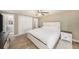 Spacious main bedroom includes wood-look tile flooring, a ceiling fan, and double closet at 15525 Old Dixie Hwy, Hudson, FL 34667
